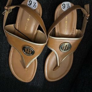 Brown slides with gold logo accent